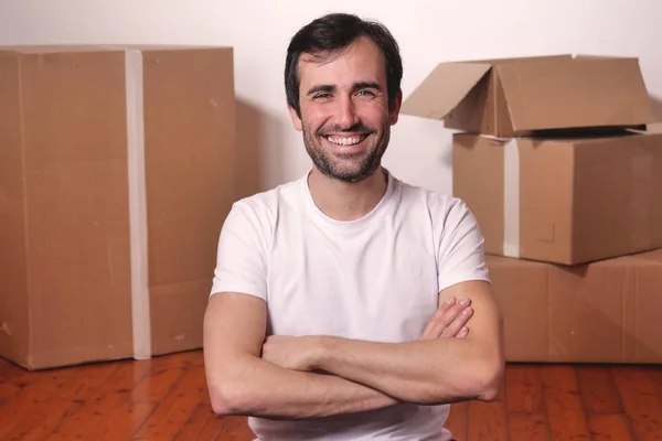 Happy Smiling Caucasian Man Looking Camera Arms Crossed Boxes Background — Stock Photo, Image