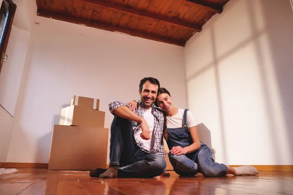 Portrait of a loving couple who is buying the new house and moving away. The couple are smiling and happy with the futuristic project together. Concept of: future, family, design and projects.