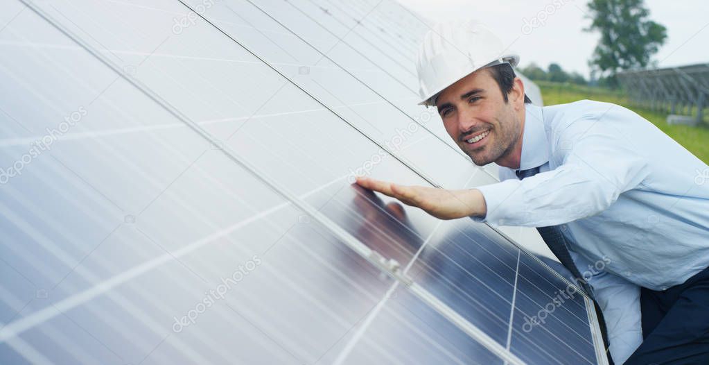Caucasian businessman touching eco solar panels, roof cells solar system station