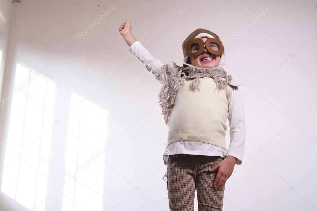 playful adorable little girl dressed as pilot 