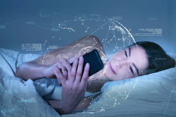 brunette woman lying in bed and browsing smartphone with abstract futuristic hi tech graphic