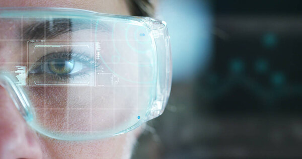 partial view of woman wearing goggles, eye and futuristic interface hologram