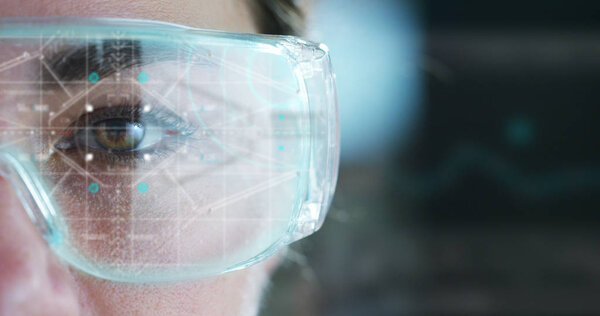 partial view of woman wearing goggles, eye and futuristic interface hologram