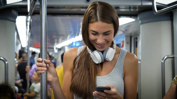 幸せに 携帯電話で音楽を聞いて美しい若い女の子 の肖像画は 地下鉄で笑顔 コンセプト 愛の生活 ライフ スタイル 旅行への愛 — ストック写真