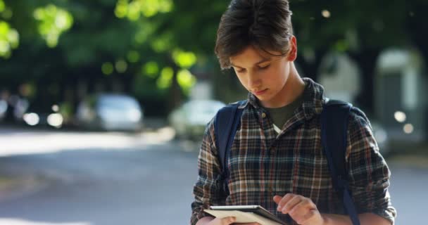 Video Teenager Boy Using Digital Gadget While Standing Outdoors Sunny — Stock Video