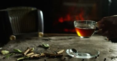 güzel romantik bileşimi bitkisel çaylar ve bu arka plan ve bir şömine baharat ile eski bir ahşap kesme tahtası üzerinde dökülür varlık iken çay