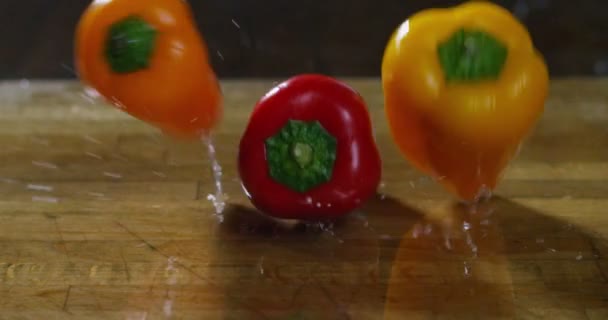 Talian Colored Peppers Jumping Bouncing Wooden Cutting Board Extreme Slow — Stock Video