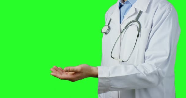 Doctor Man Standing Green Background Gesturing Hand Showing Partial View — Stock Video