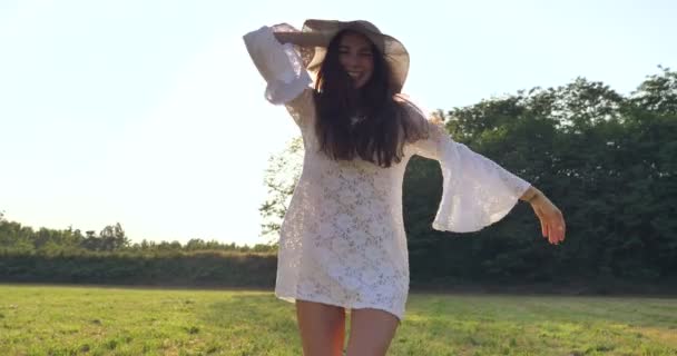 在户外的草地上 穿着白色夏装的快乐微笑的女人慢动作视频 — 图库视频影像
