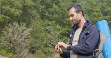  doğada ayakta ve cep telefonuyla uzun yürüyüşe çıkan kimse seyahat etmek insanın yavaş hareketli video 