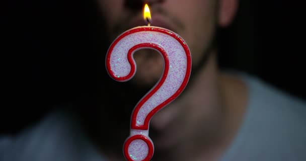 Slow Motion Video Man Blowing Question Mark Burning Candle — Stock Video