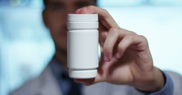 Video Man Doctor Wearing White Coat Showing White Medicine Bottle — Stock Video