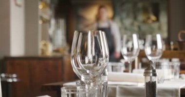 Müşteriler geliyor ve iyi çatal ve gözlük kullanır önce garson tablo lokantada ayarlar. Kavramı: catering, tasarım, romantik yemekler