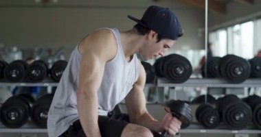 Salondaki, gömleksiz adam vücudu fit kalmak ve kasları tanımlamış olduğunuz için eğitiyor. Atlet ağır ağırlık ve yorgunluk yükseltir. Kavramı: spor, spor salonu, kas ve fitness