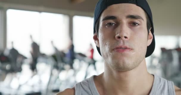 A shirtless guy at the gym, trains his body to stay fit and have defined muscles. The athlete raises heavy weights and fatigue. Concept of: sport, gym, muscles and fitness — Stock Footage Shirtless Guy Gym Trains His Body Stay Fit Have Defined Royalty Free Stock Video