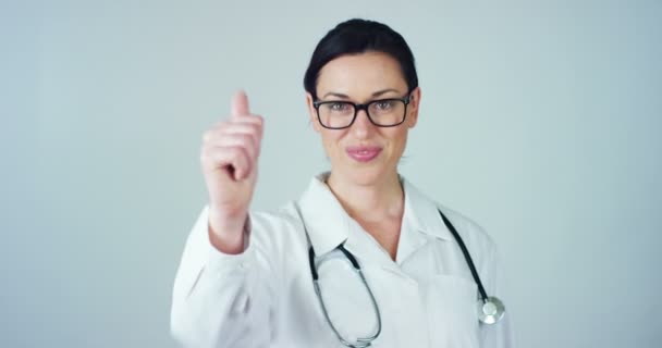 video z žena lékaře s bílý plášť a stetoskop směřují palec nahoru