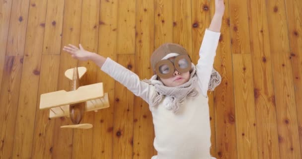 Video Playful Adorable Little Girl Dressed Pilot Lying Wooden Floor — Stock Video