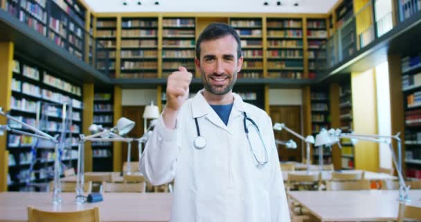 Young Beautiful Doctor Library Smiling Happy Holding Books Doing Search — Stock Video