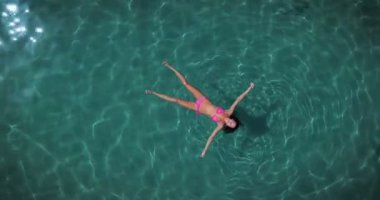 havadan görünümü video şeffaf deniz su içerisinde yüzen kadın 