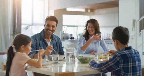 Portrait of happy family having lunch in dining room. Concept of healthy food, wellbeing, happy family