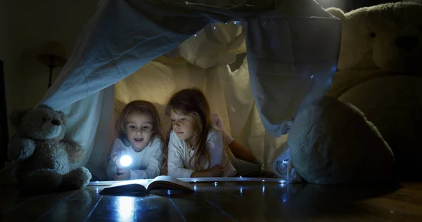 Duas Meninas Irmãs Crianças Lêem Histórias Escuro Sob Cobertor Iluminando — Fotografia de Stock