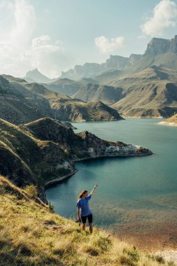 Kadın, Elbrus bölgesindeki güzel gölün tadını çıkarıyor.