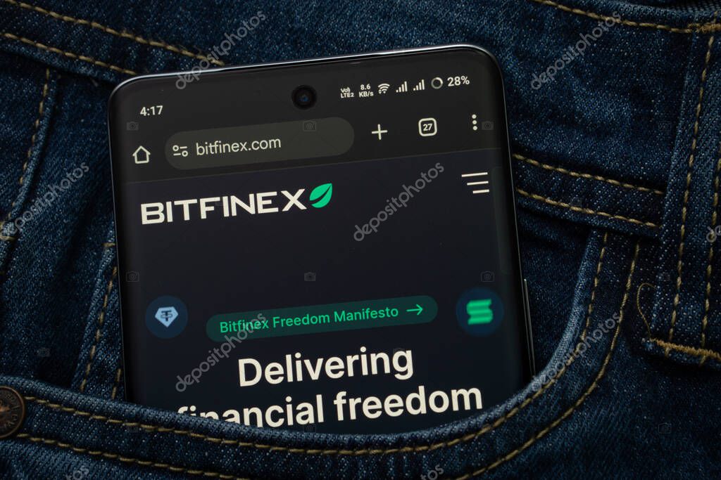 Dhaka, Bangladesh- 15 June 2025: A smartphone displaying the Bitfinex.com web interface peeks out of a denim pocket.