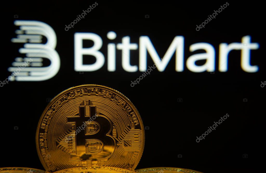 Dhaka, Bangladesh- 03 Sep 2025: Close-up of Bitcoin coins with the Bitmart logo visible on a screen in the background.