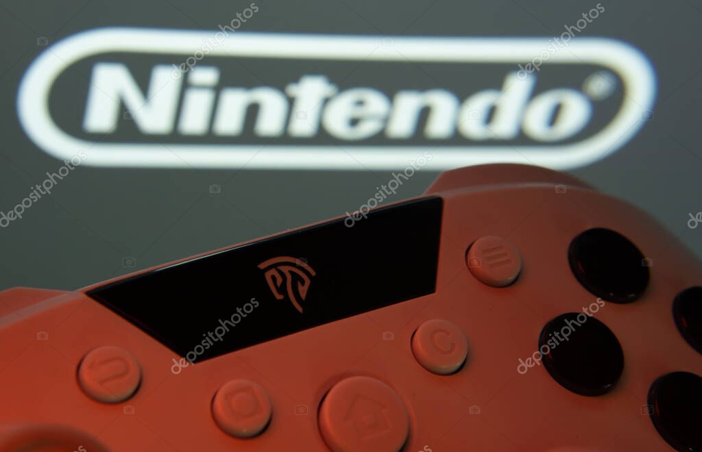 Dhaka, Bangladesh- 15 July 2025: A close-up of a gamepad with the nintendo seen on screen in the background.