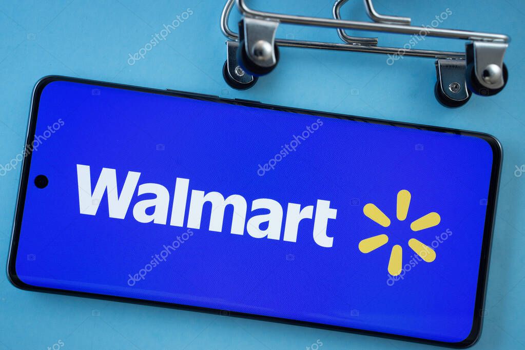 Dhaka, Bangladesh- 03 July 2025: Smartphone screen showing the Walmart logo with shopping cart wheels on a blue background.