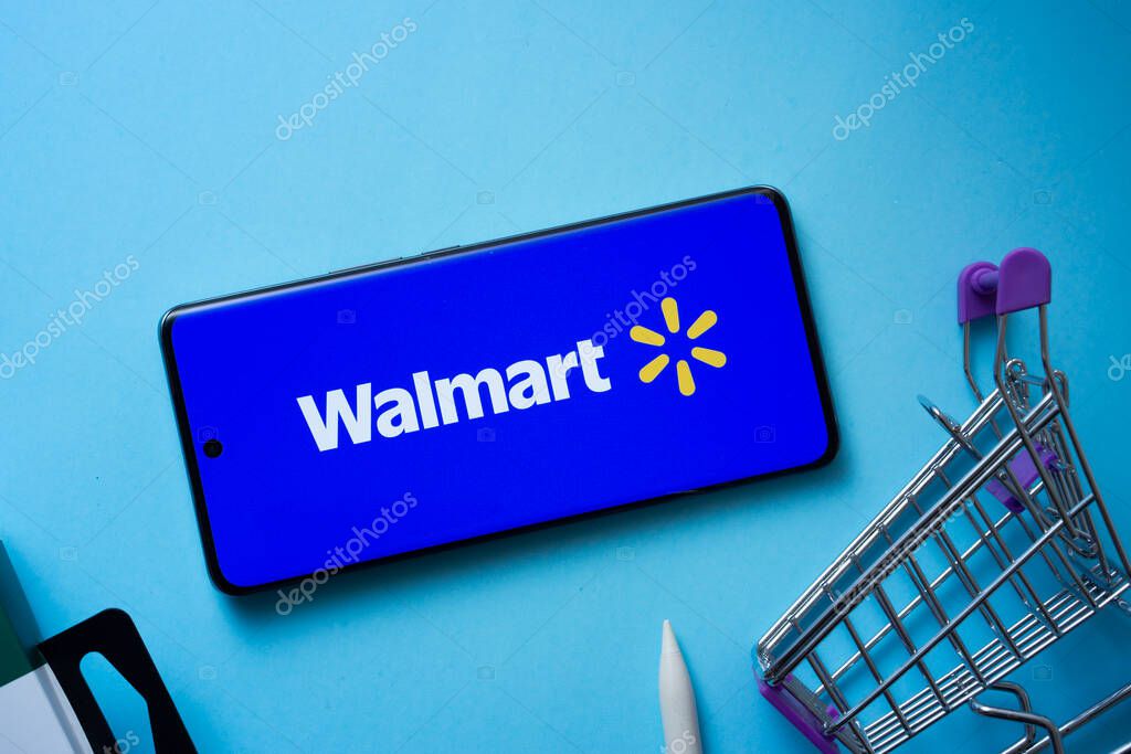Dhaka, Bangladesh- 03 July 2025: Smartphone displaying Walmart logo with shopping cart on a blue background.