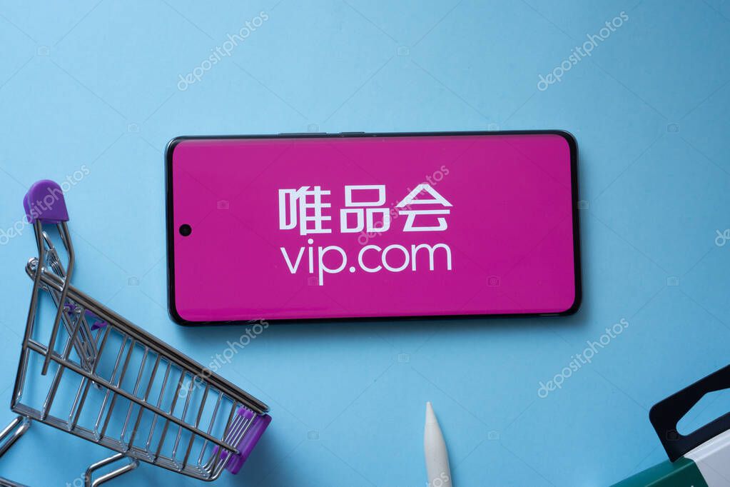 Dhaka, Bangladesh- 03 July 2025: Smartphone displaying vip.com logo with shopping cart on a blue background.