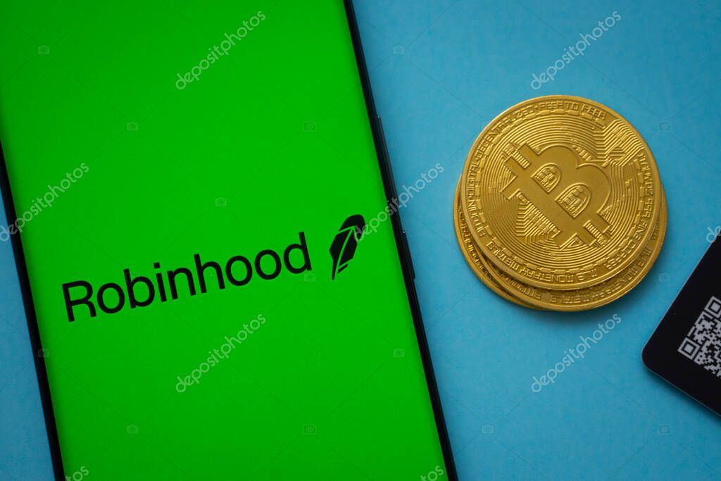 Dhaka, Bangladesh- 26 Aug 2025: Robinhood logo on smartphone screen near Bitcoin coin and QR code on blue background.