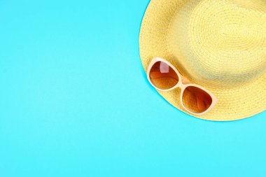 Şapka, güneş gözlüğü bir pastel üzerinde arka plan mavi.