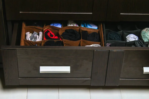 Organization of storage of socks and panties in the drawer of the chest of drawers, cabinet