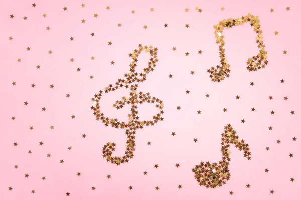 Muzieknoten Voor Sterrenhemel Gouden Confetti Liggend Een Roze Pastel Achtergrond — Stockfoto
