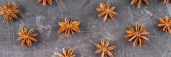 star anise on a gray dark concrete background.