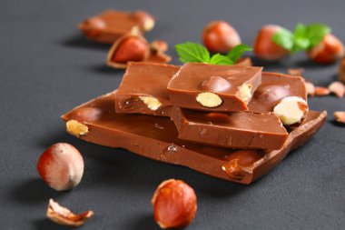 Çikolata fındık, nane ve koyu gri masada kahve taneleri