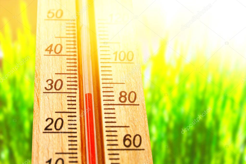 Thermometer displaying high 30 degree hot temperatures in sun summer day