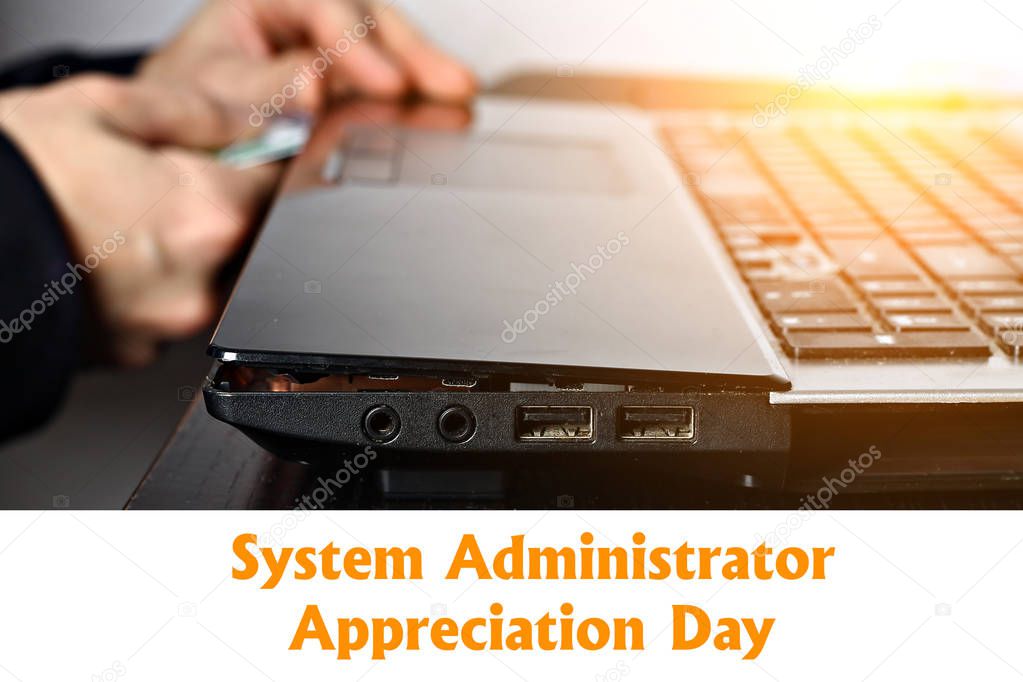 System Administrator Appreciation Day. Postcard for the holiday. The guy is fixing the laptop