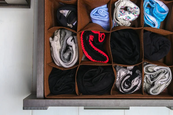 Organization of storage of socks and panties in the drawer of the chest of drawers, cabinet