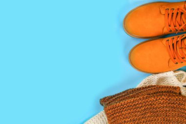 Turuncu kahverengi erkek sonbahar bir mavi pastel arka plan üzerinde botlar. Üstten görünüm, kopya alanı