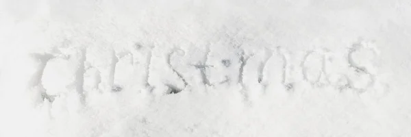 The inscription Christmas on the snow. Text, letters