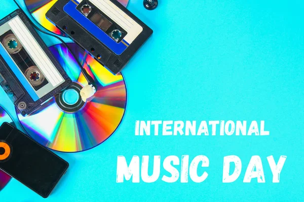 World, international music day. The concept of the evolution of music. Cassette, CD-disk, mp3 player. Vintage and modernity. Music support