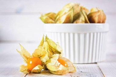 Egzotik meyveler physalis Beyaz ahşap bir masa üzerinde