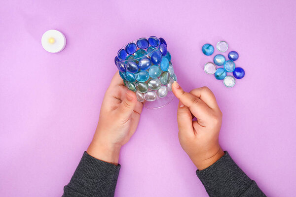 How to make your own candlestick from unnecessary glass or plastic and glass pebbles. Step by step. Christmas interior decor