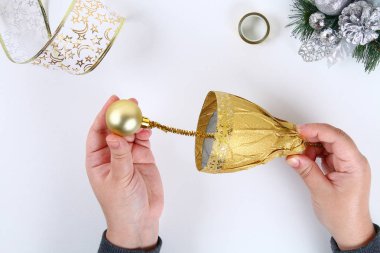 Bir plastik şişe DIY altın çan. Fotoğrafta bir şişe, kağıt ve bir Noel top kendi elleriyle dekoratif bir çan yapmak nasıl Kılavuzu. El yapımı Noel dekor. Üstten görünüm. Adım adım