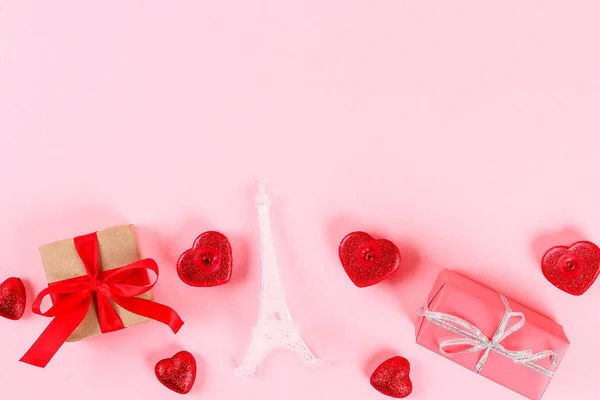 Valentine day layout. Gifts, hearts, Eiffel Tower on a pink pastel background. St. Valentines Day, day love, February 14 concept. Copy space, top view, flat lay composition