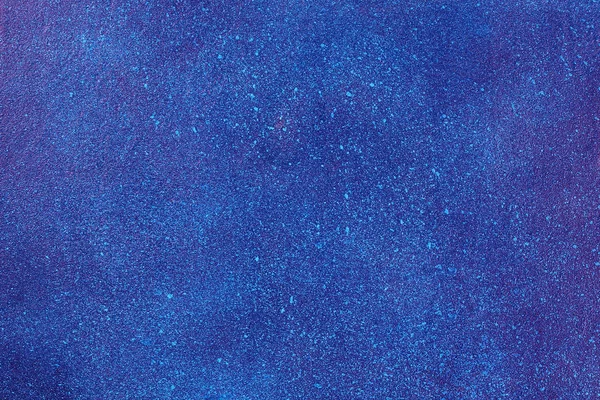 Space texture on painted plywood. The texture of the night starry sky. Blue-purple texture background. Copy space. Top view. Spray paint in the form of stars.