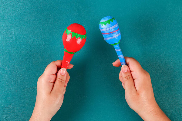 Diy cinco de mayo maracas из яиц, ложек и орехов на зеленом фоне
.